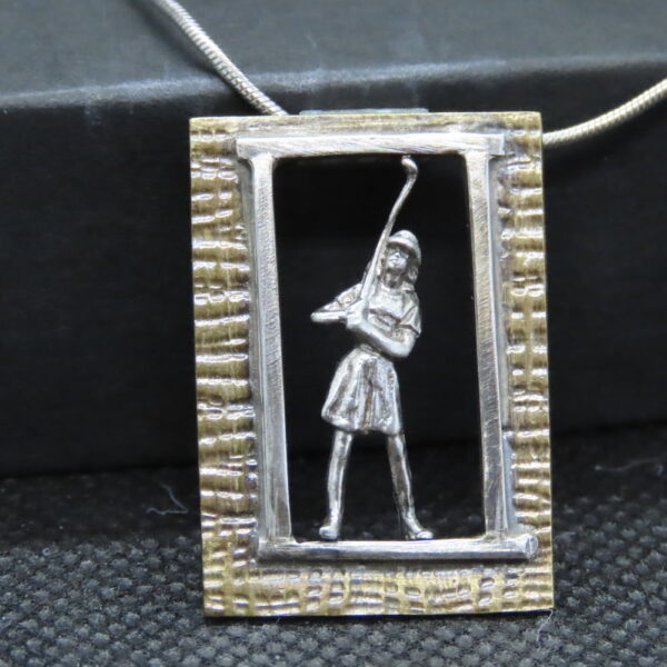 One-of-a-kind miniature female human golfer. Tiny Tales. Mixed metal. silver figure, silver/brass frame. Silver chain