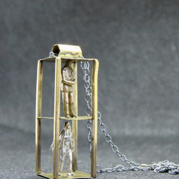 Unique 2-level brass "cage style" w/sterling human figures Handmade brass frame. Mixed metals: Bronze and Silver Figures. 18" oxidized silver chain
