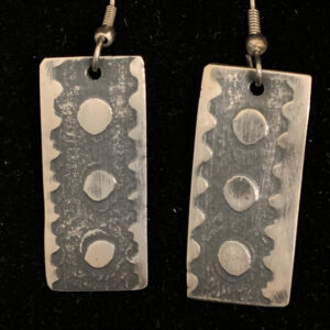 Handmade, oxidized silver, embossed by cut paper in press. Silver ear wires